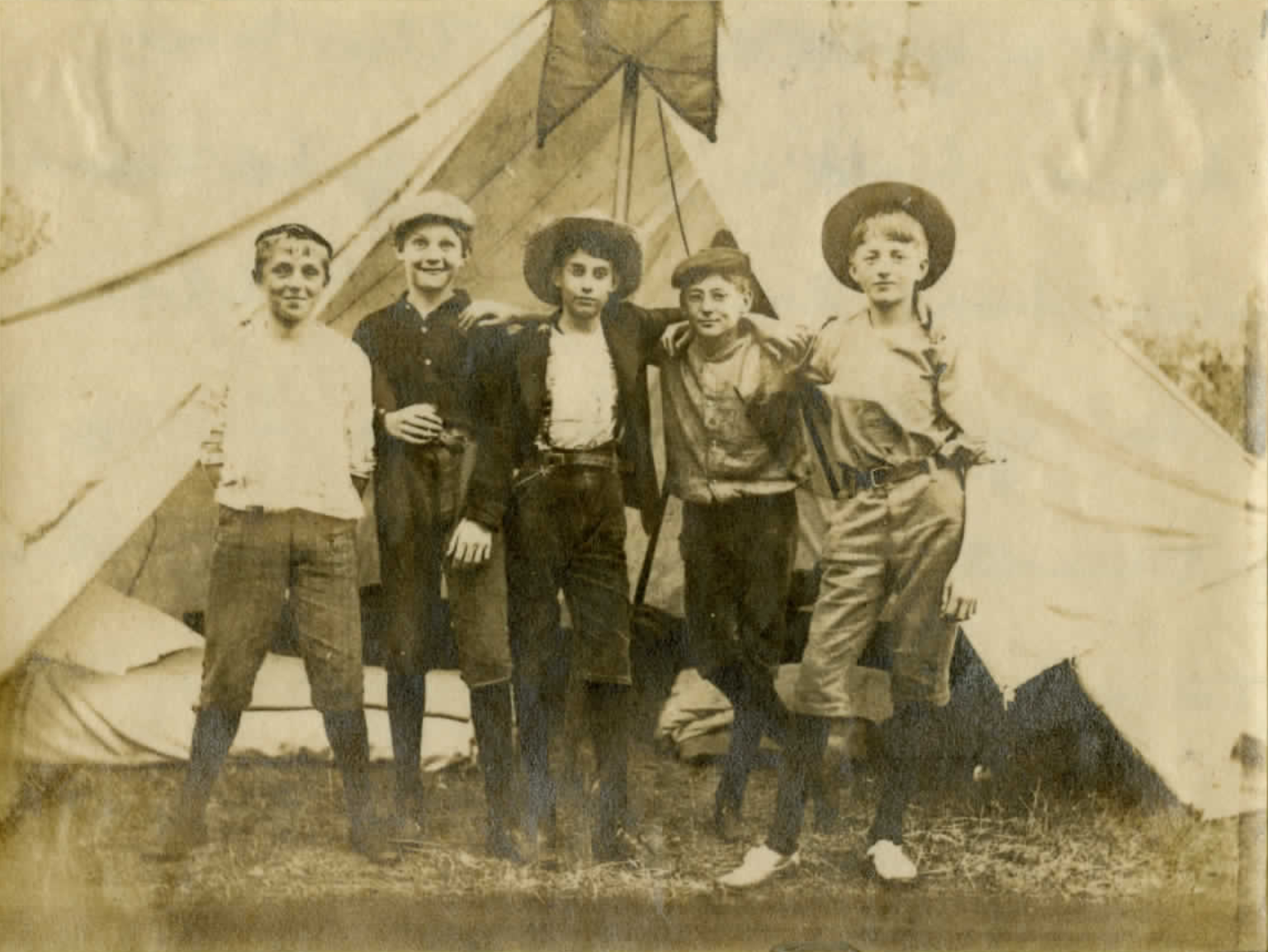 Vintage photograph of five boys in front of a tent, circa early 1900s — from the Passmore Family Archive